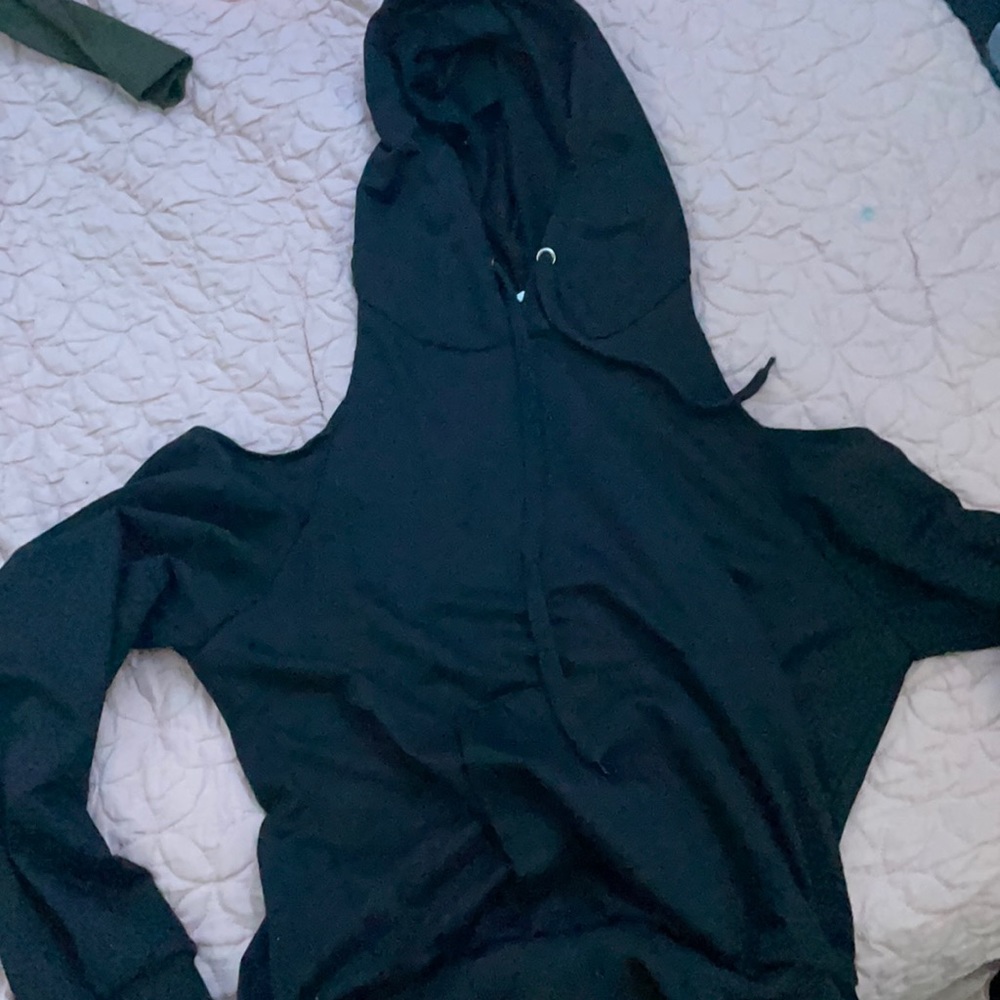 A black hoodie with no shoulders but long sleeve